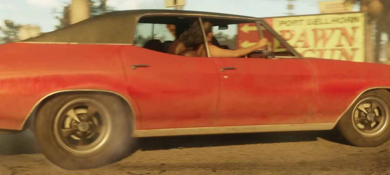 A red four-door muscle car passing the Port Gellhorn pawn and gun shop. Reported as a Declasse Tulip.