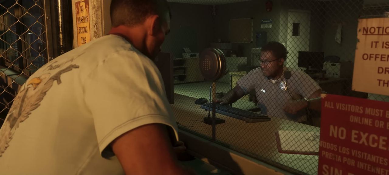 A prison office, a guard behind the desk, notices on the wall.