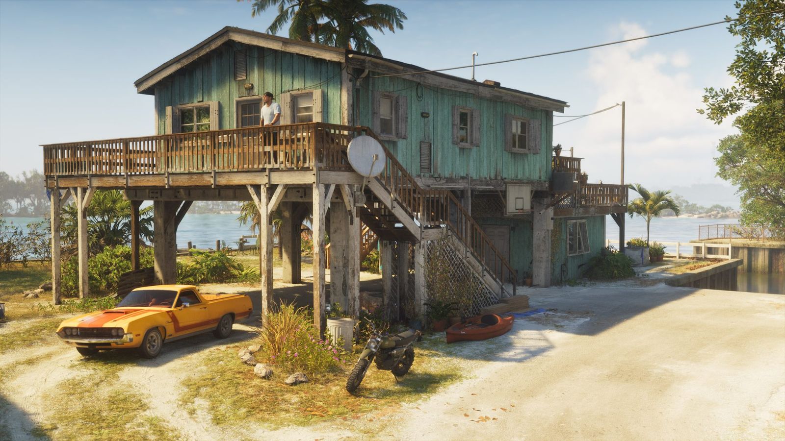 A stilt house in the Leonida Keys with a muscle car, a dirt bike and a kayak outside